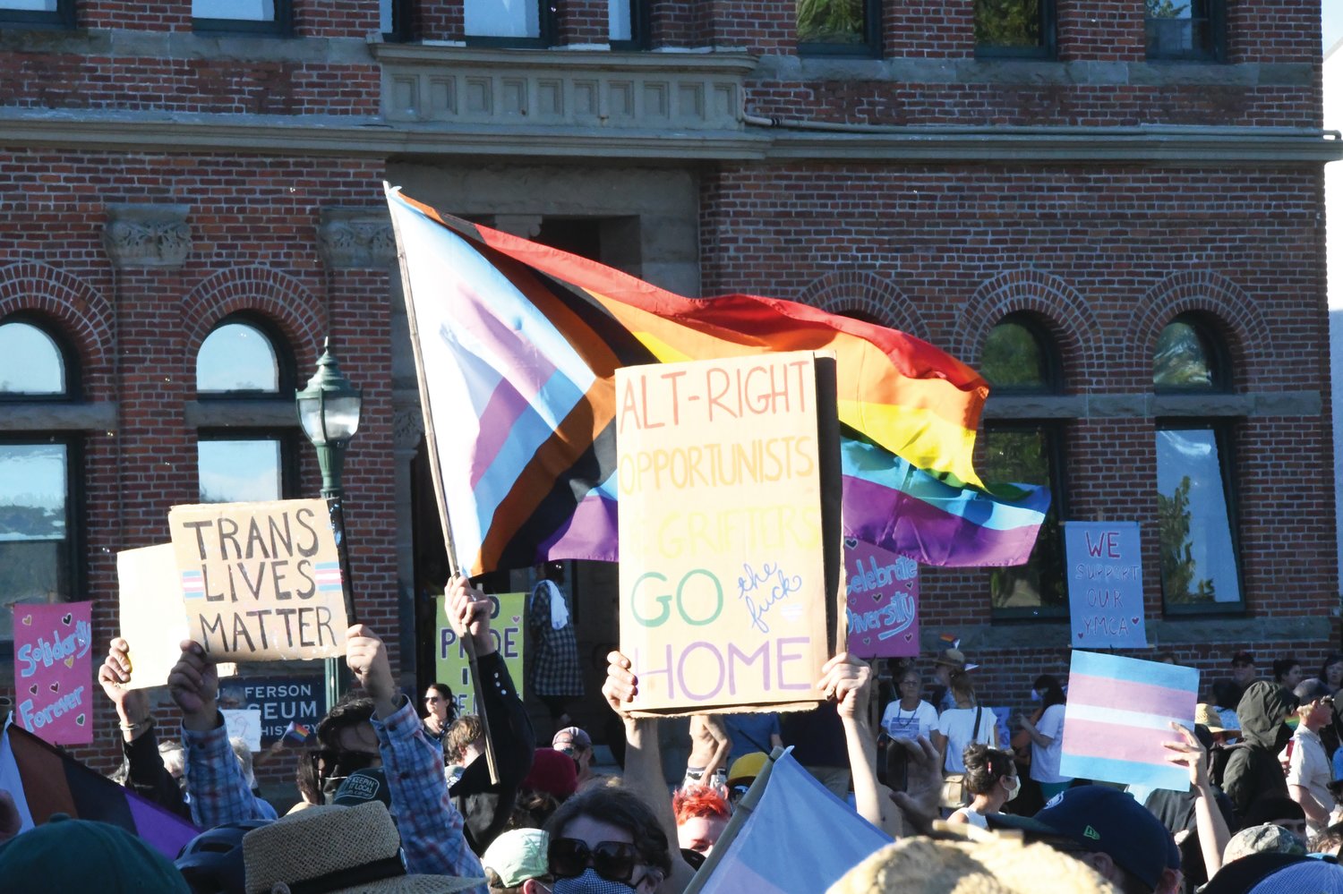 Hundreds of protesters gathered at Pope Marine Park, bearing Pride flags and signs supporting the LGBTQ+ community.
