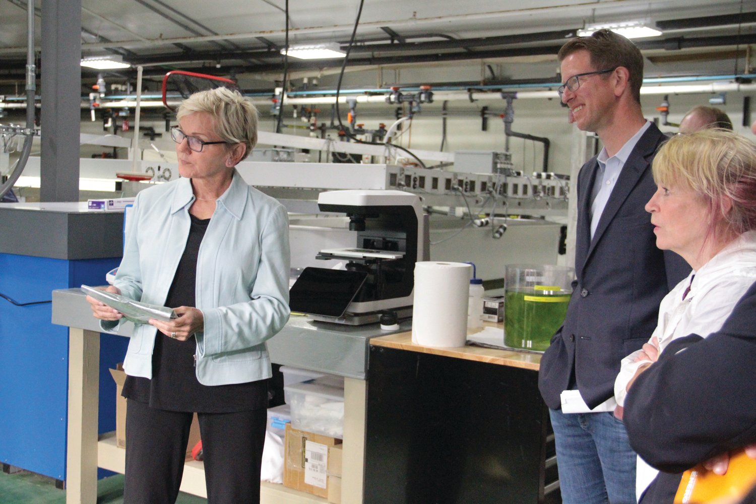 U.S. Secretary of Energy Jennifer M. Granholm talks with researchers at the Pacific Northwest National Laboratory-Sequim while touring the research facility with Congressman Derek Kilmer.