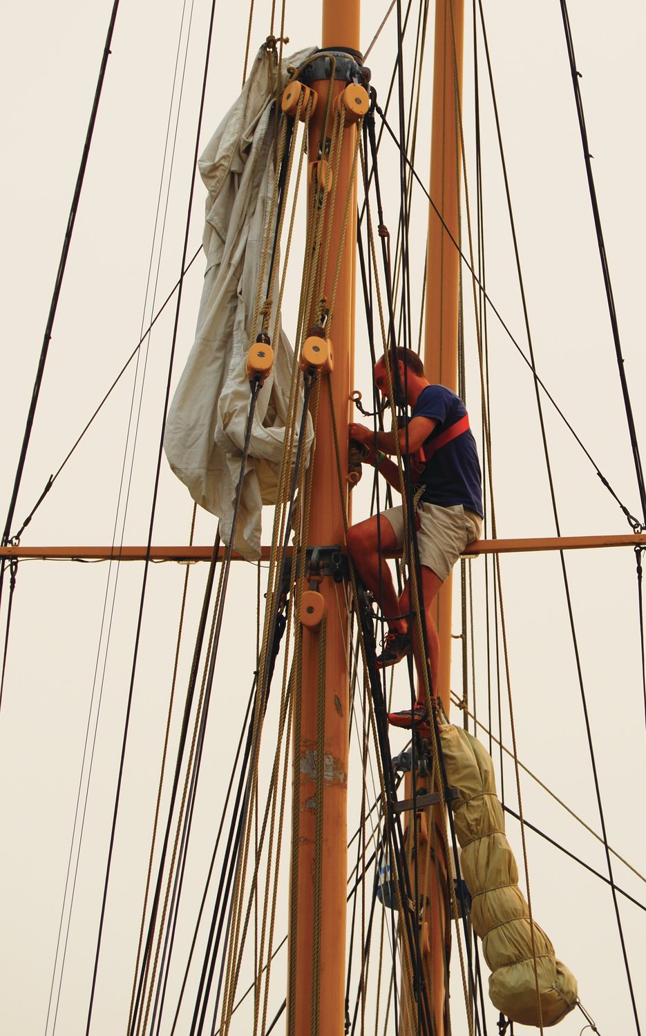 Griffin Hoins of Port Townsend readies the rigging of Alcyone in preparation for the schooner race.
