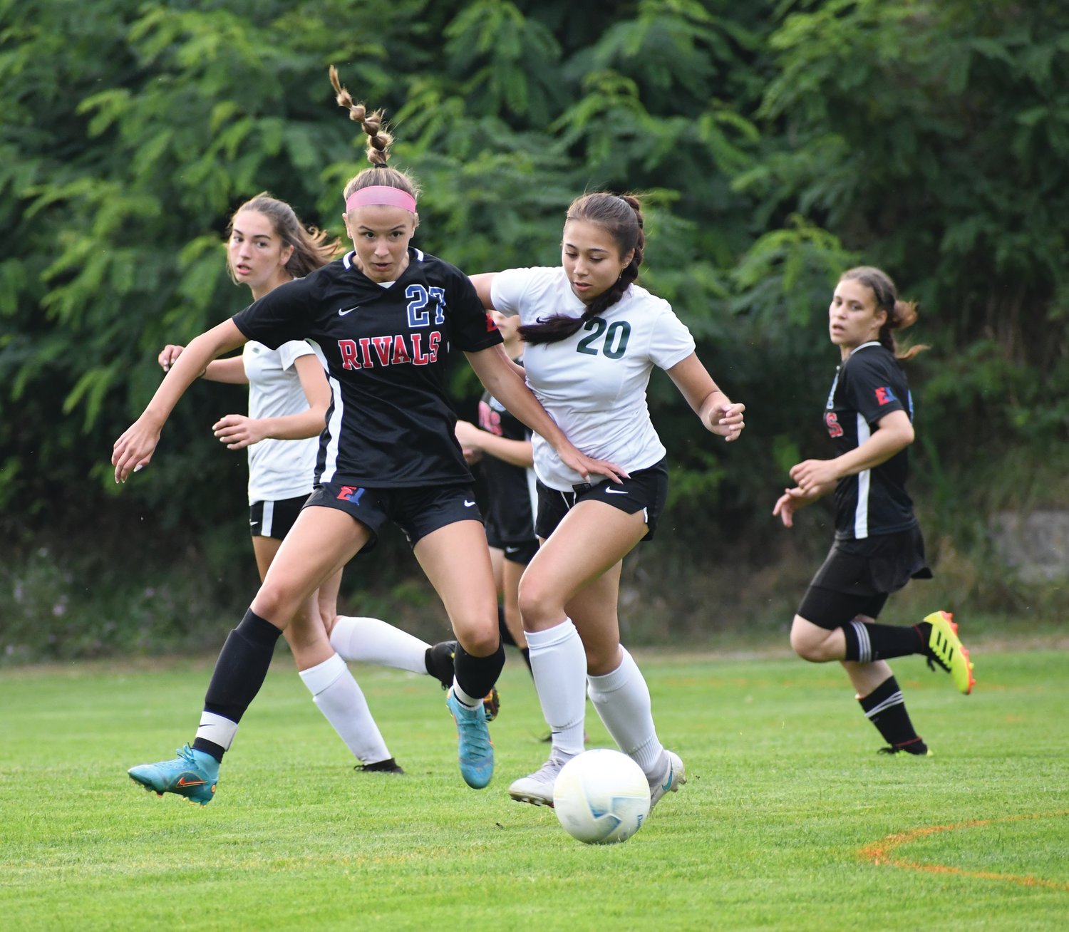 EJ midfielder Iris Mattern collects the ball before looking to loft a pass towards her teammate in the opening half of play.