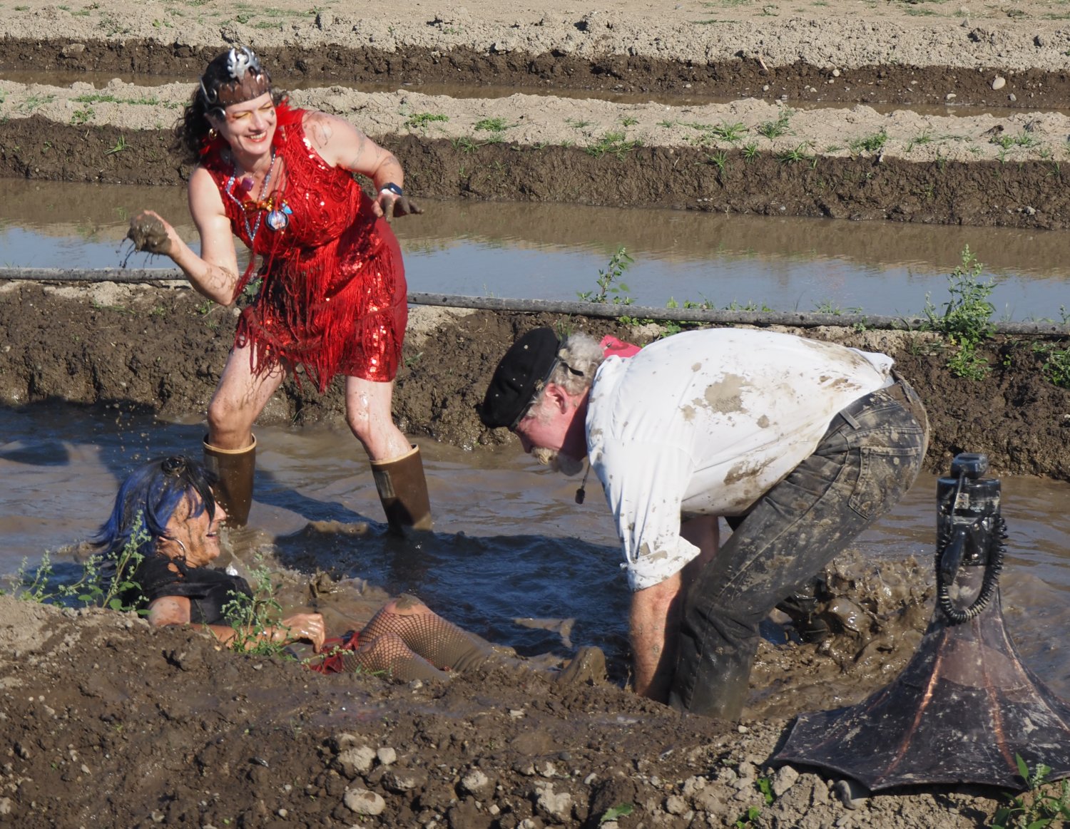 Newly elected Kween Pheanamix, aka Anami Cloud, proves her might in the mud over Kimberly Snow, fully immersed in the muck, and Nathan Barnett.