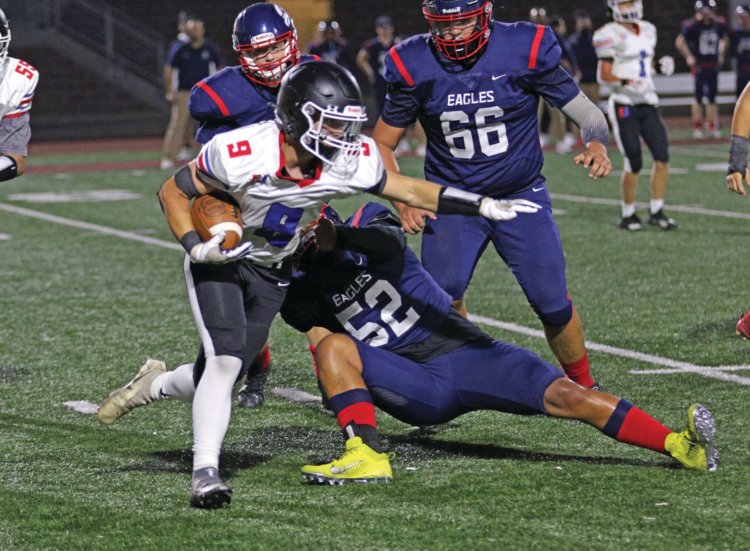 EJ running back Aaron Glanz is wrapped up during a run by an Eagle defender.