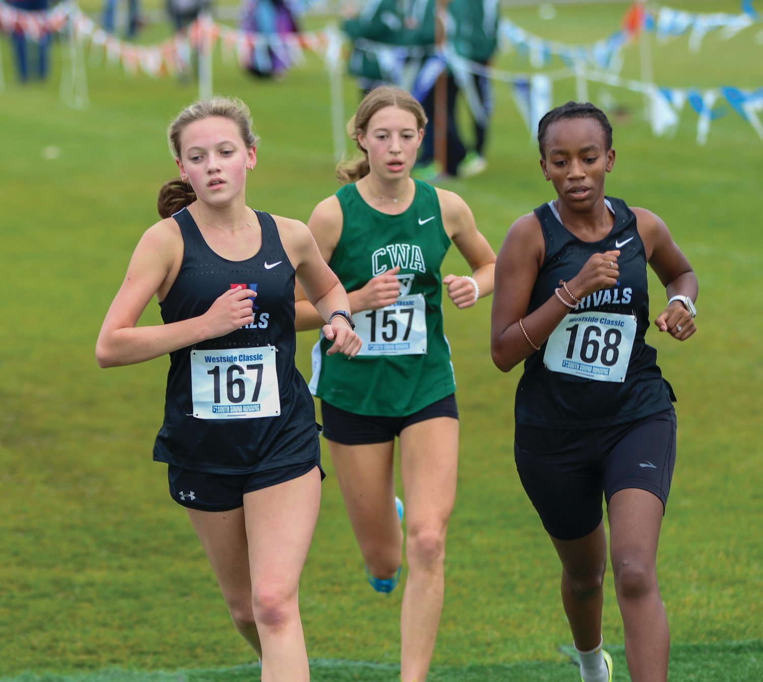 EJ’s Sylvia Butterfield (left) and Tadu Dollarhide (right) compete in the District Championship race to secure top-10 spots, and help to win gold for the girls team.