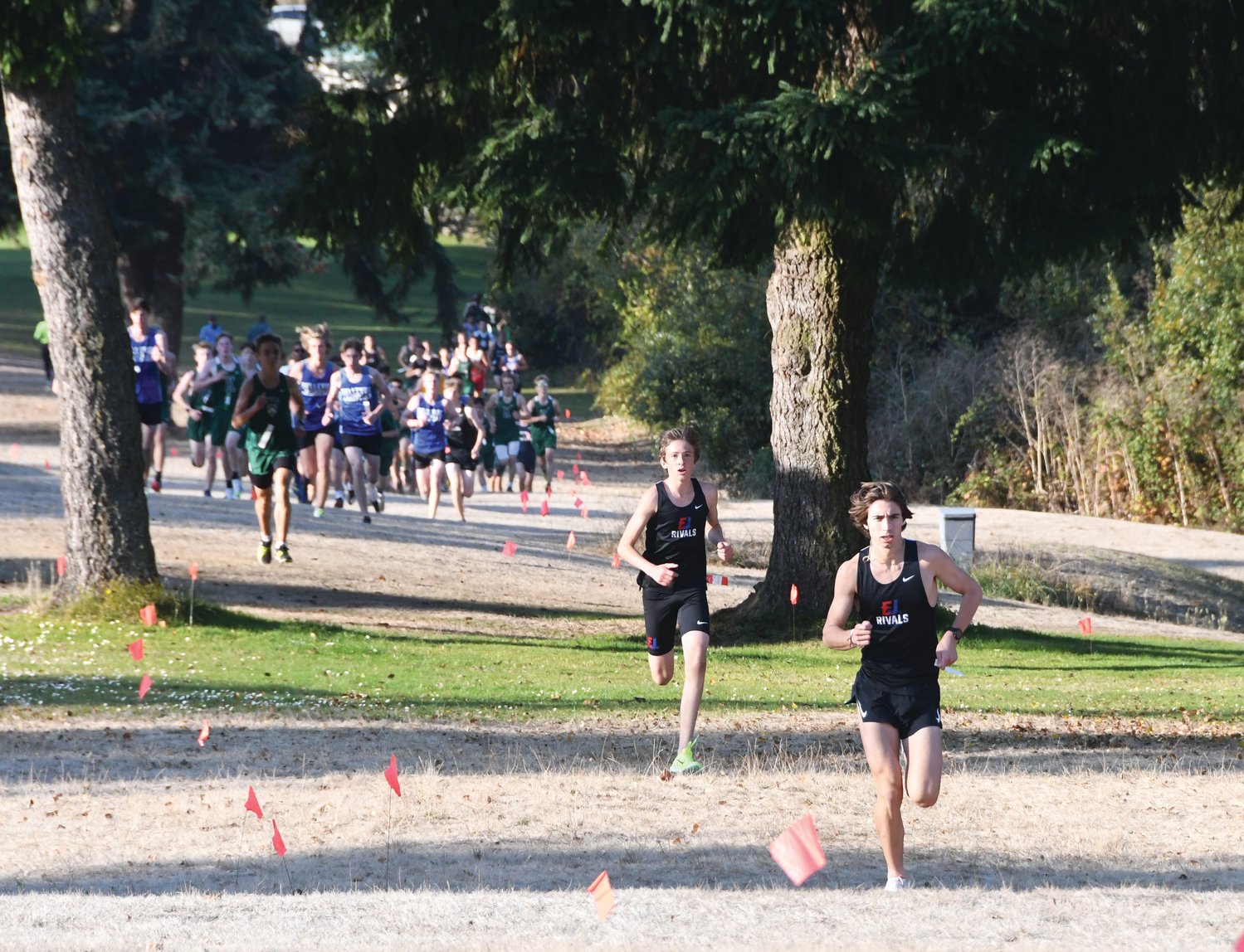 Rivals runners Soare Johnston and Sebastian Manza dash through the Port Townsend Golf Course during their October home meet.