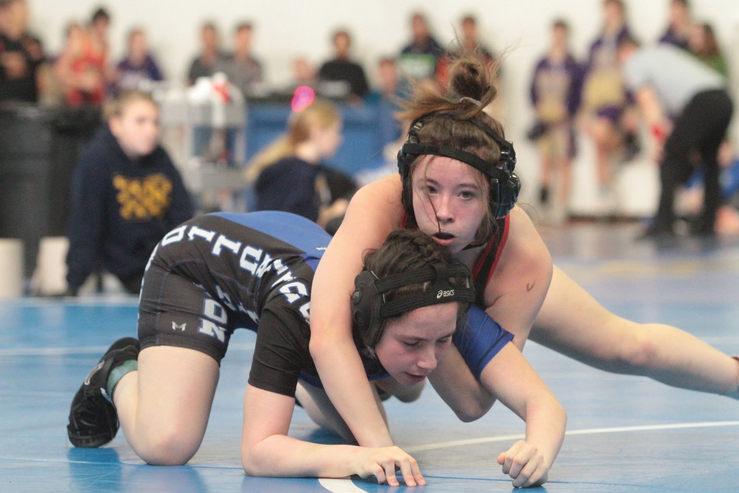 Rivals freshman Akili Clevenger controls her competitor from the top while wrestling Saturday.