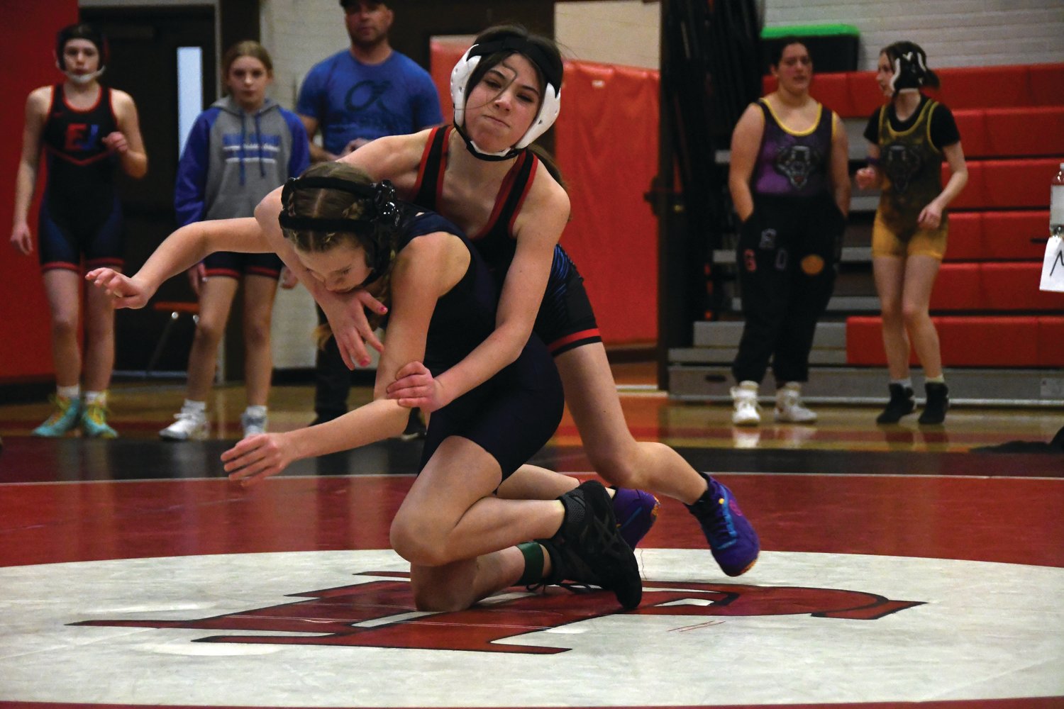 Blue Heron seventh-grader Savannah Grimm secures a takedown, toppling her Port Angeles opponent.