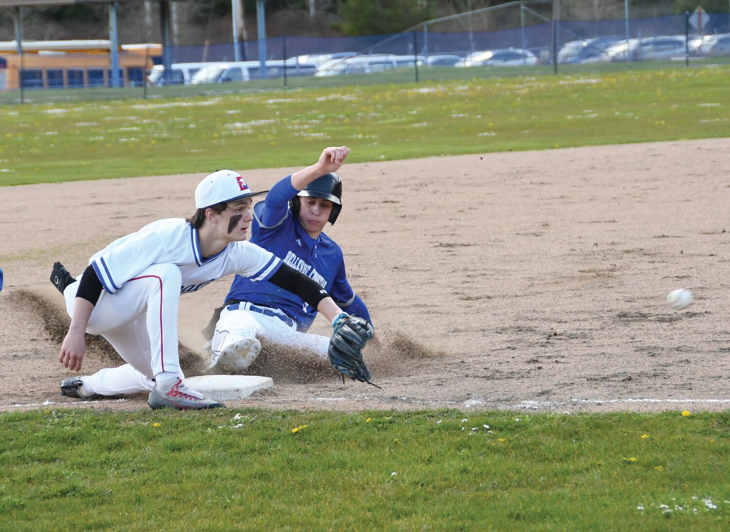 EJ junior Brody Moore prepares to snatch the ball and make the tag at third base after a Bellevue Christian player slides in to make the steal.