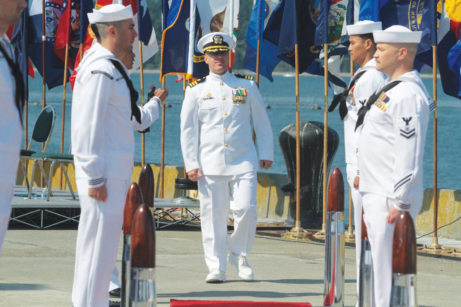 Navy Cmdr. Todd Galvin, the new commanding officer of Naval Magazine Indian Island, is piped aboard during a change of command ceremony at the Navy installation Thursday.